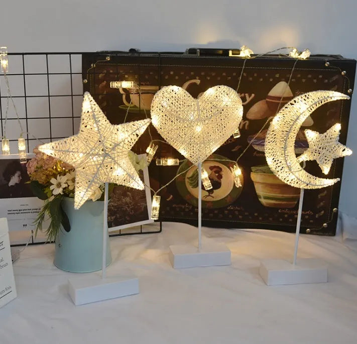 Rattan and PC LED decorative lamp in star, heart, or moon shape on a table.