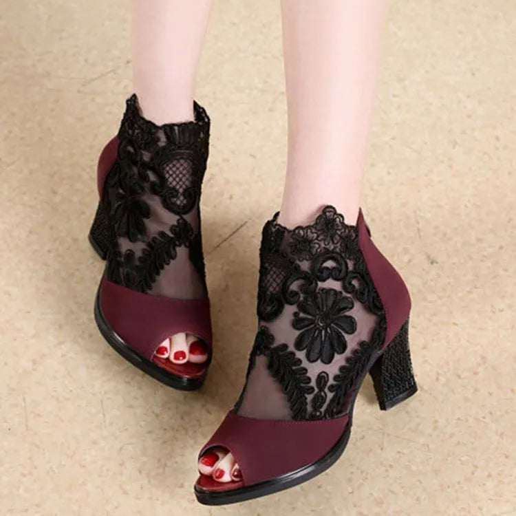 Women's black gladiator sandals with flower lace detailing, square heels, and zip closure