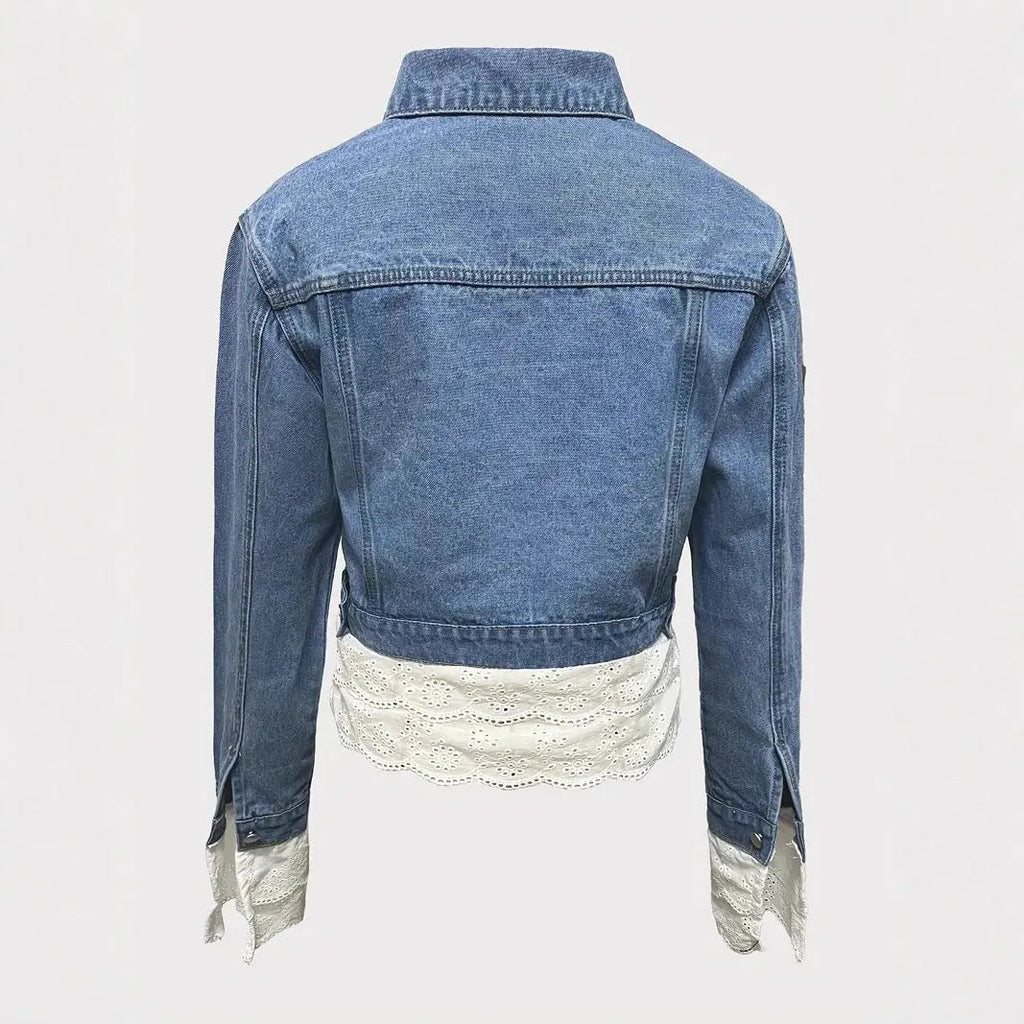 Blue women's denim jacket with decorative lace stitching on the front, long sleeves.