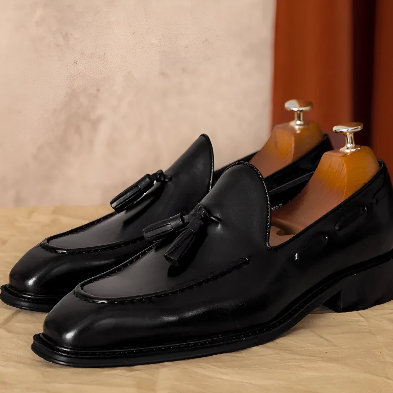 Men's black genuine leather slip-on loafers with fringed detail and rubber sole