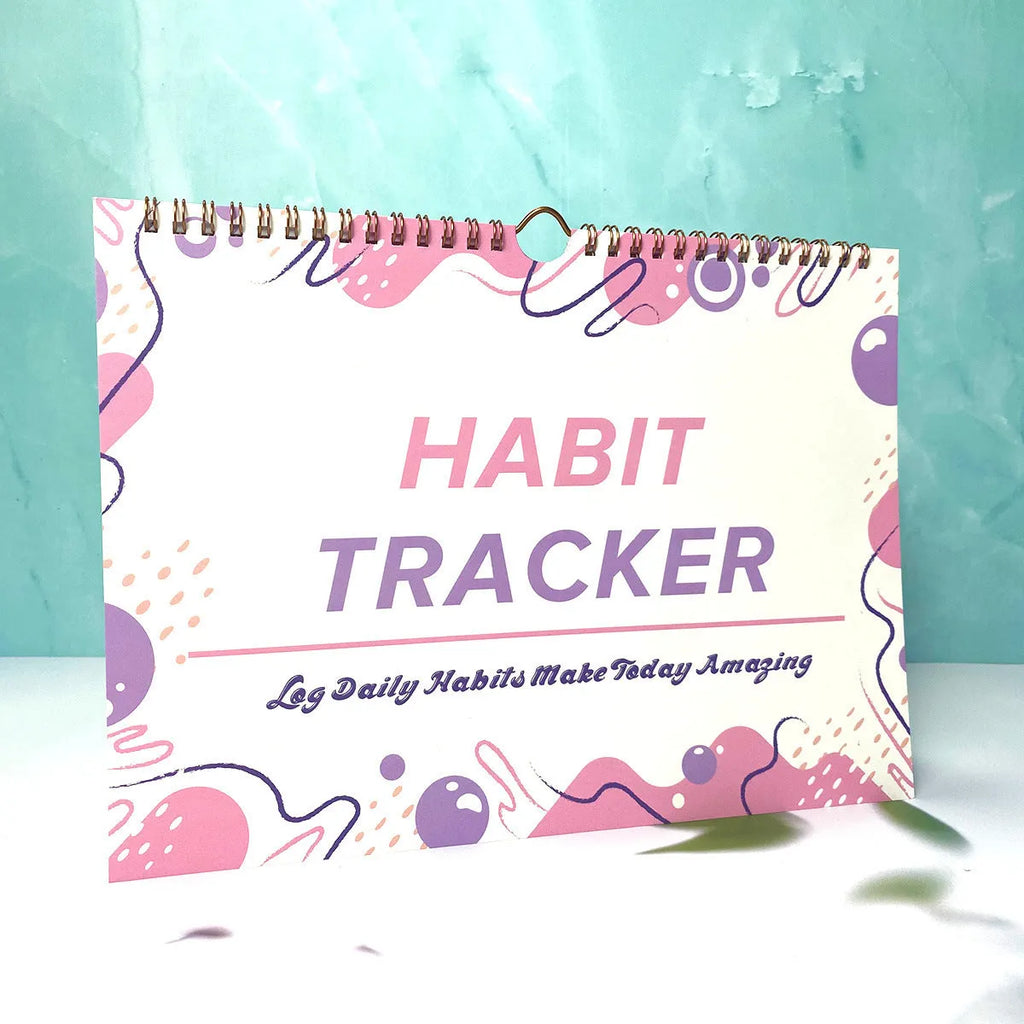 Habit tracking journal notebook open showing planning pages with colour options