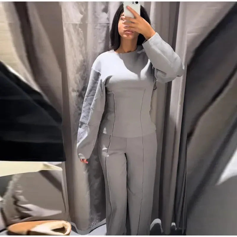 Women's black polar fleece trouser suit set with pleated long sleeve top and wide-leg pants on a hanger.