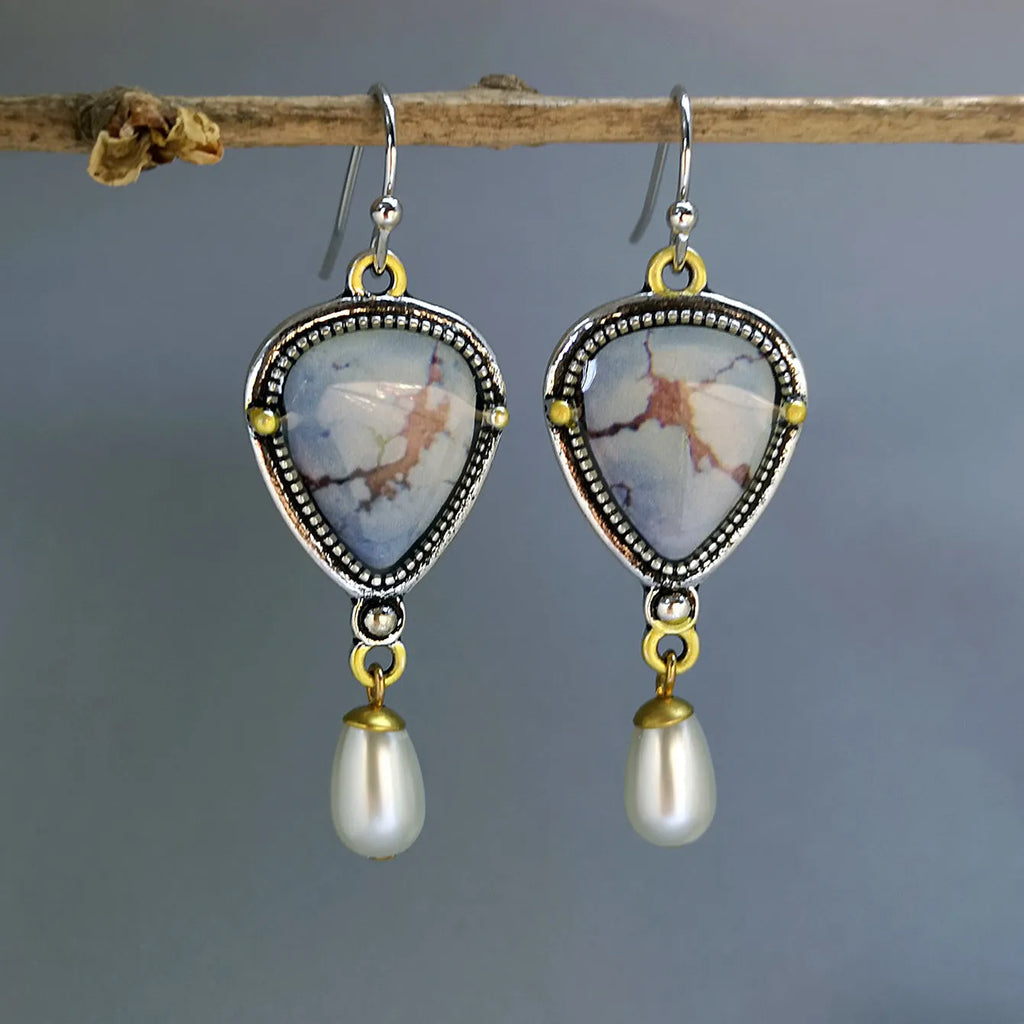 Retro blue drop earrings with synthetic blue opal and white pearl on electroplated metal.