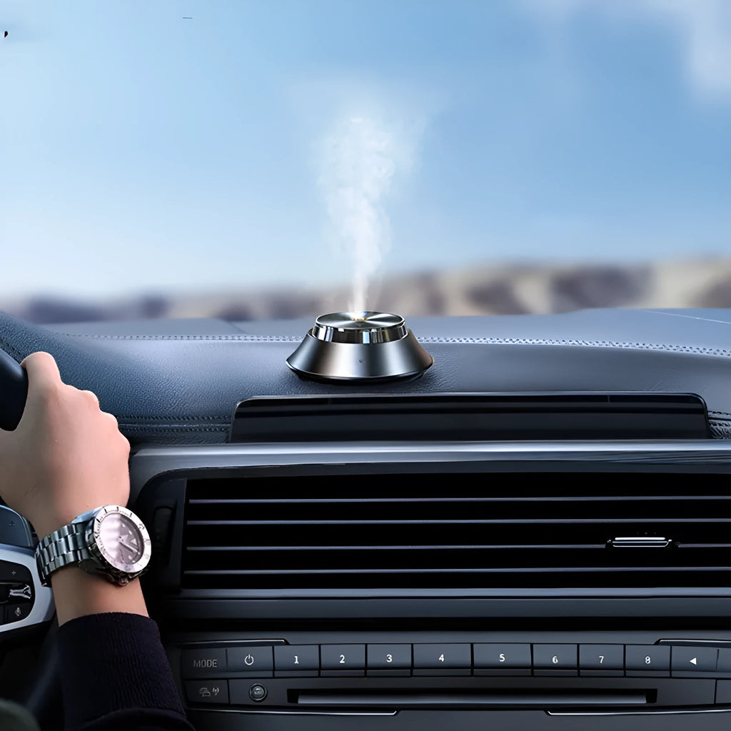 Black metal butterfly car aromatherapy air purifier with USB cable and essential oil bottle.