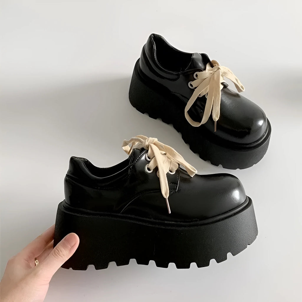 Matte black women's lace-up ankle boots with a chunky 6-8 cm heel and thick rubber sole.