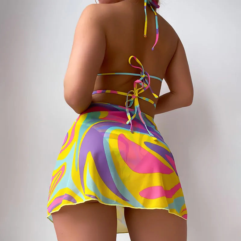 Yellow striped halter-neck swimsuit with lace-up front, includes matching skirt and shorts