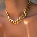 Women's gold tone thick chain necklace showing alloy construction with electroplated finish