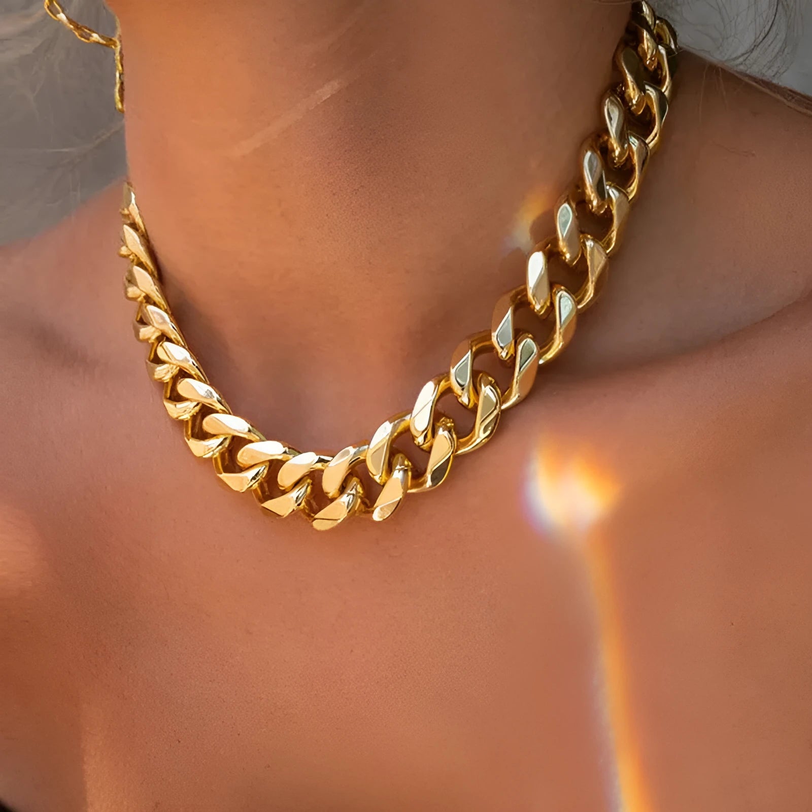 Women's gold tone thick chain necklace showing alloy construction with electroplated finish
