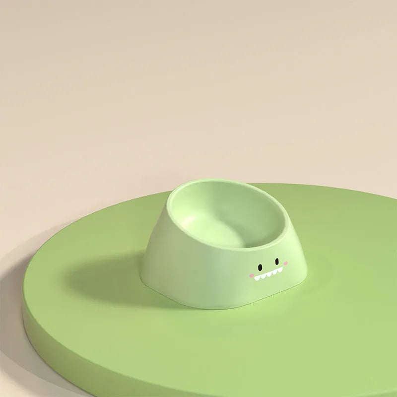 Green tilted stainless steel cat bowl with non-slip white base at a 15 degree angle