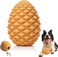 Yellow pine cone shaped dog chew toy with treat dispenser on textured surface