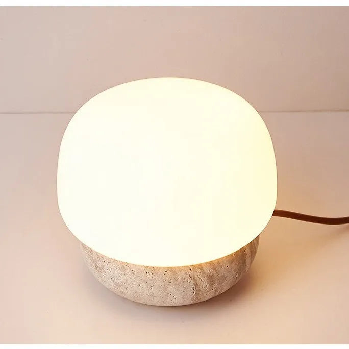 Cream coloured retro bedside lamp with a button switch on a wooden surface.