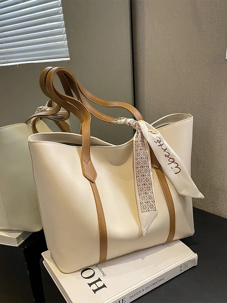 Large soft tote bag with crossbody strap shown in available colour options including black, khaki, white and pink