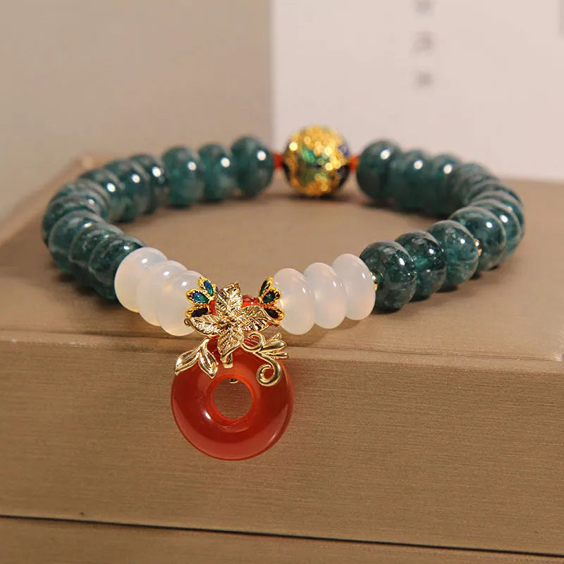 Blue water jade and red agate beaded bracelet with a peace symbol buckle clasp.