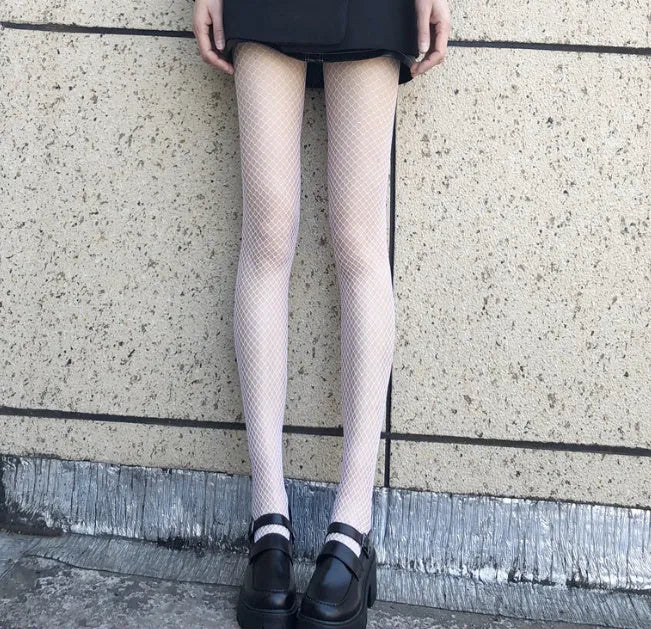 Women's mesh stockings showing large, medium and small patterns in black and white colours