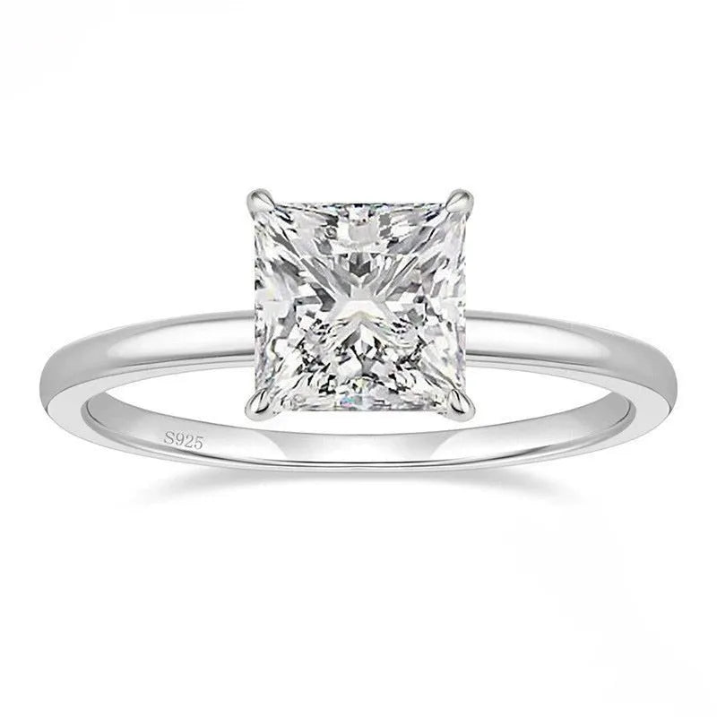 A simple geometric sterling silver ring with a round polished zirconium stone, shown in silver colour.