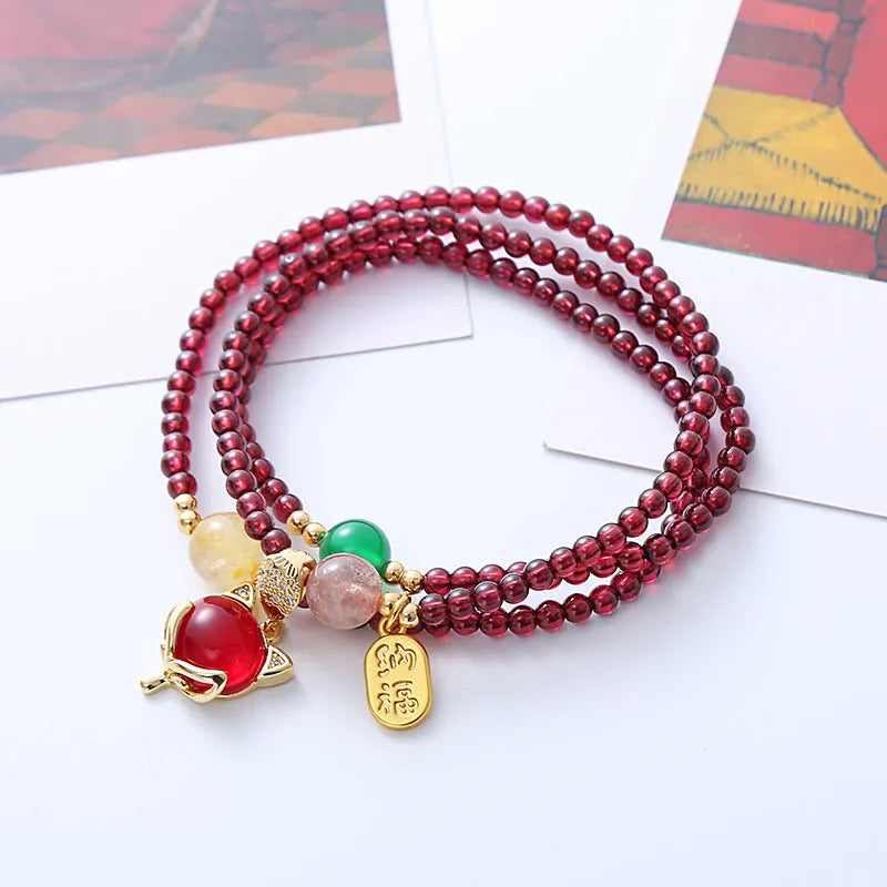 Purplish red garnet fox crystal bracelet with adjustable rope closure