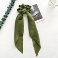 Women's long ribbon hair tie with large cloth ring, shown in sage green colour.