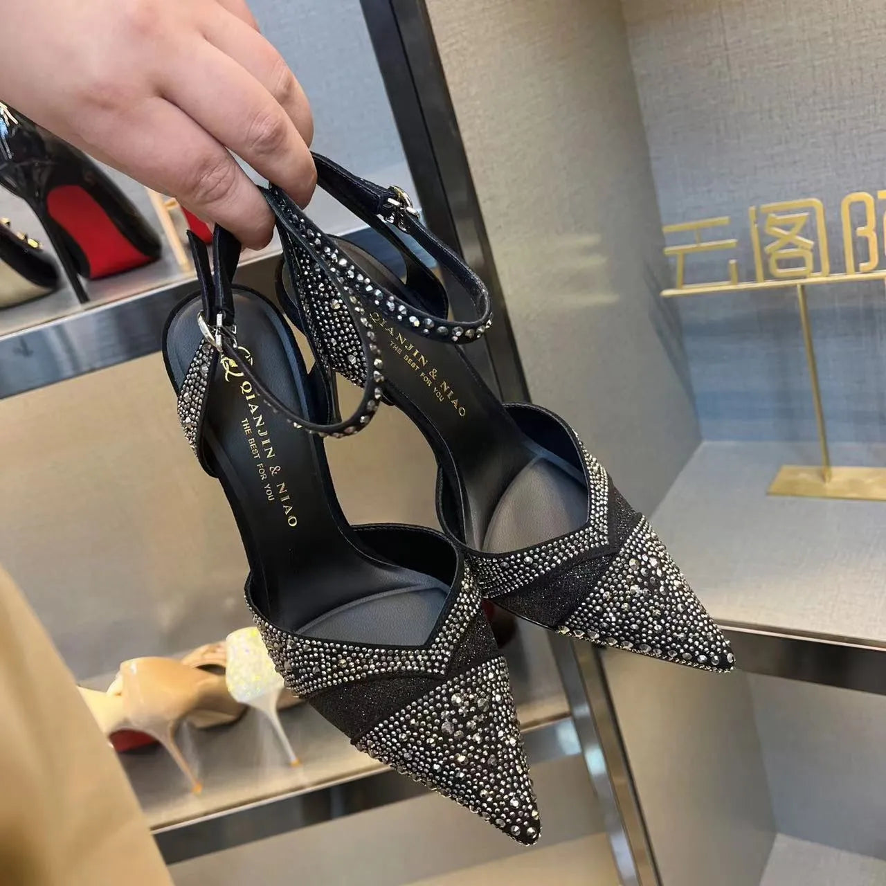 Women's black hollow high heels with stiletto heel, pointed toe, and red sole