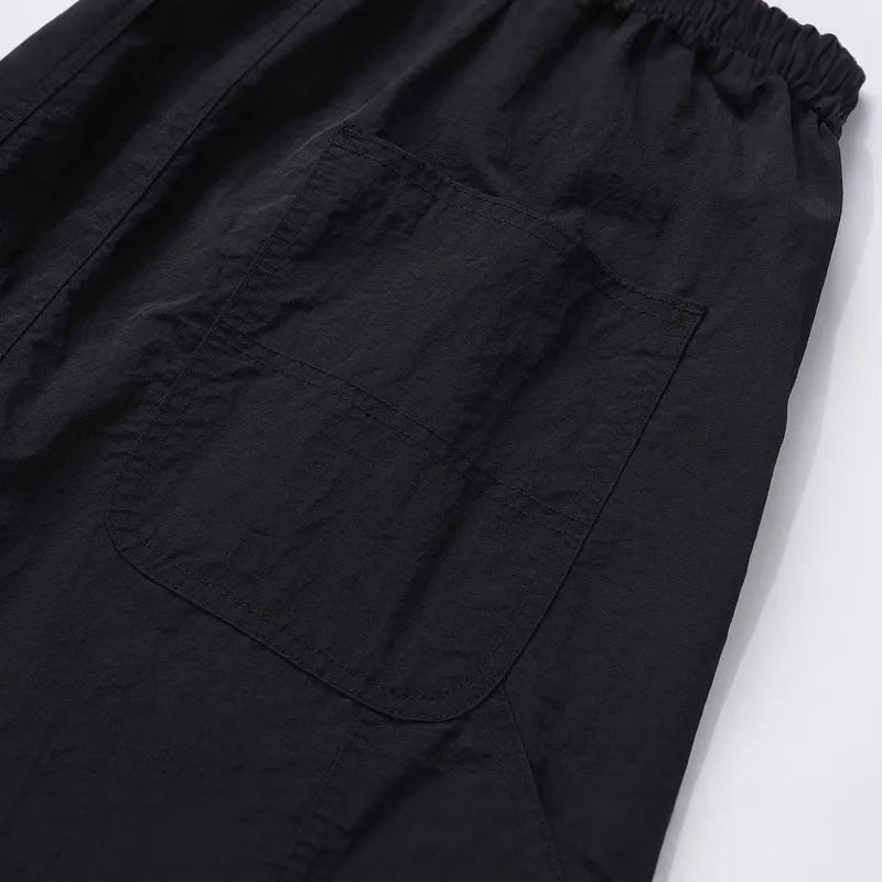 Black tooling paratrooper trousers with three-dimensional cutting and drawstring waist closure