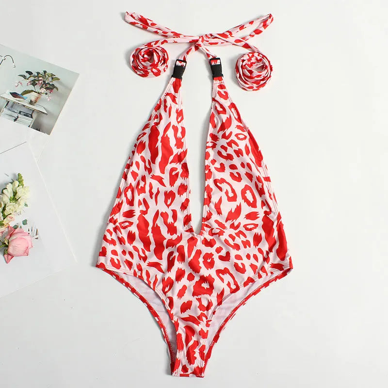 Women's one-piece leopard print swimsuit with buckle bandage detail and backless design in red or snake skin pattern
