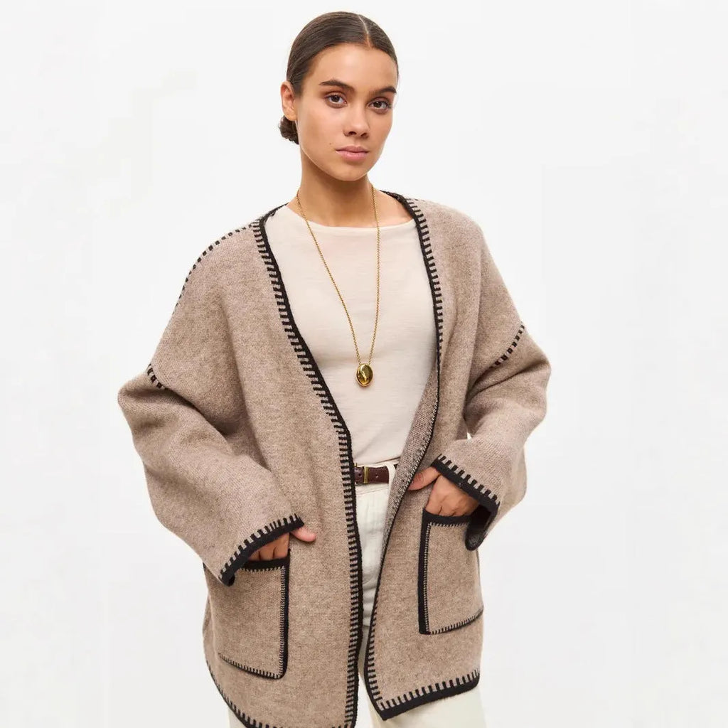 Loose fit knitted cardigan sweater in black, camel, or white colour on a hanger