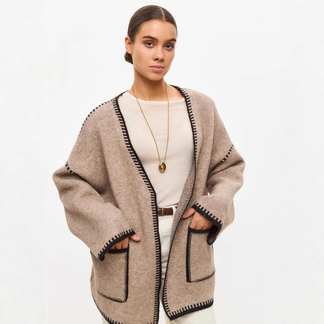 Loose fit knitted cardigan sweater in black, camel, or white colour on a hanger