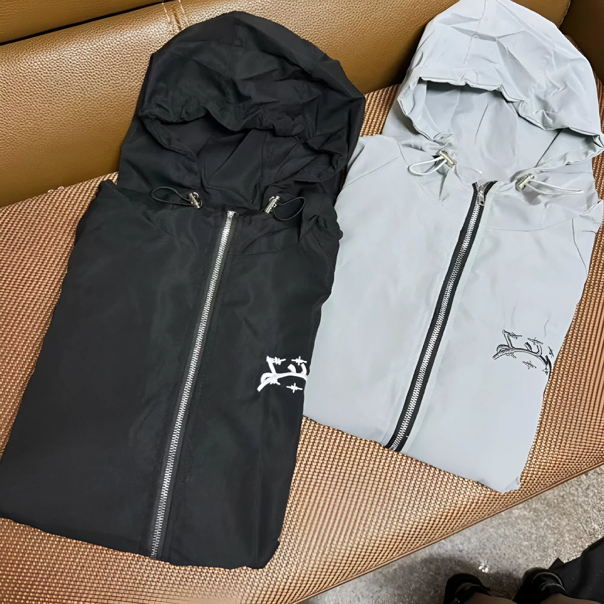 Men's grey hooded sunscreen jacket in British-style loose fit on a middle-aged man outdoors