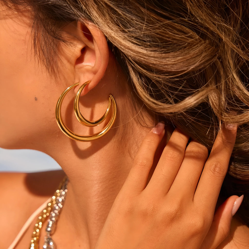 Titanium steel hoop earrings in geometric round design with gold and steel finish options