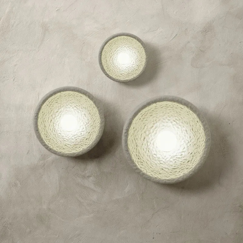Japanese-style simple silent wall lamp with a white resin shade in three size diameters.