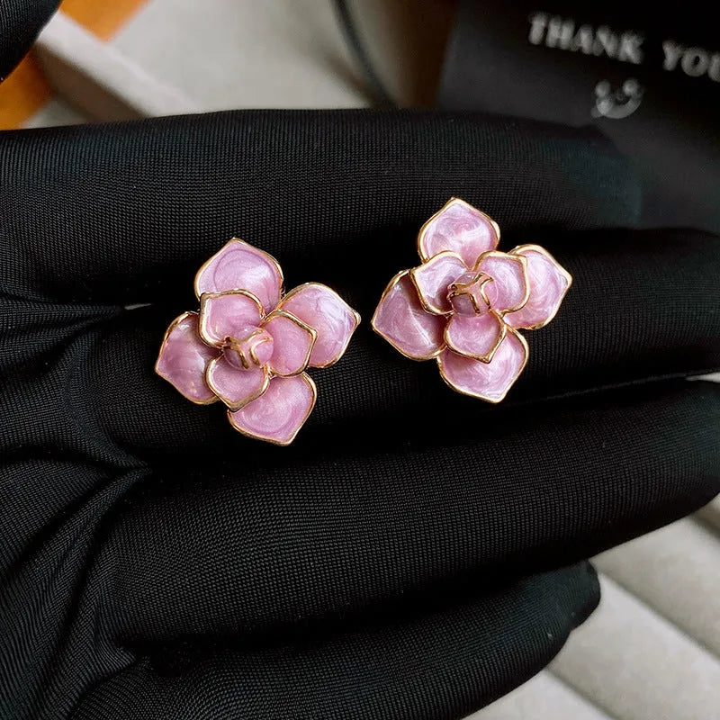 Purple oil-spot glaze floral copper stud earrings with gold-plated silver needle on white background