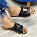 Ladies black fish mouth slippers with a bow decoration on the artificial PU upper