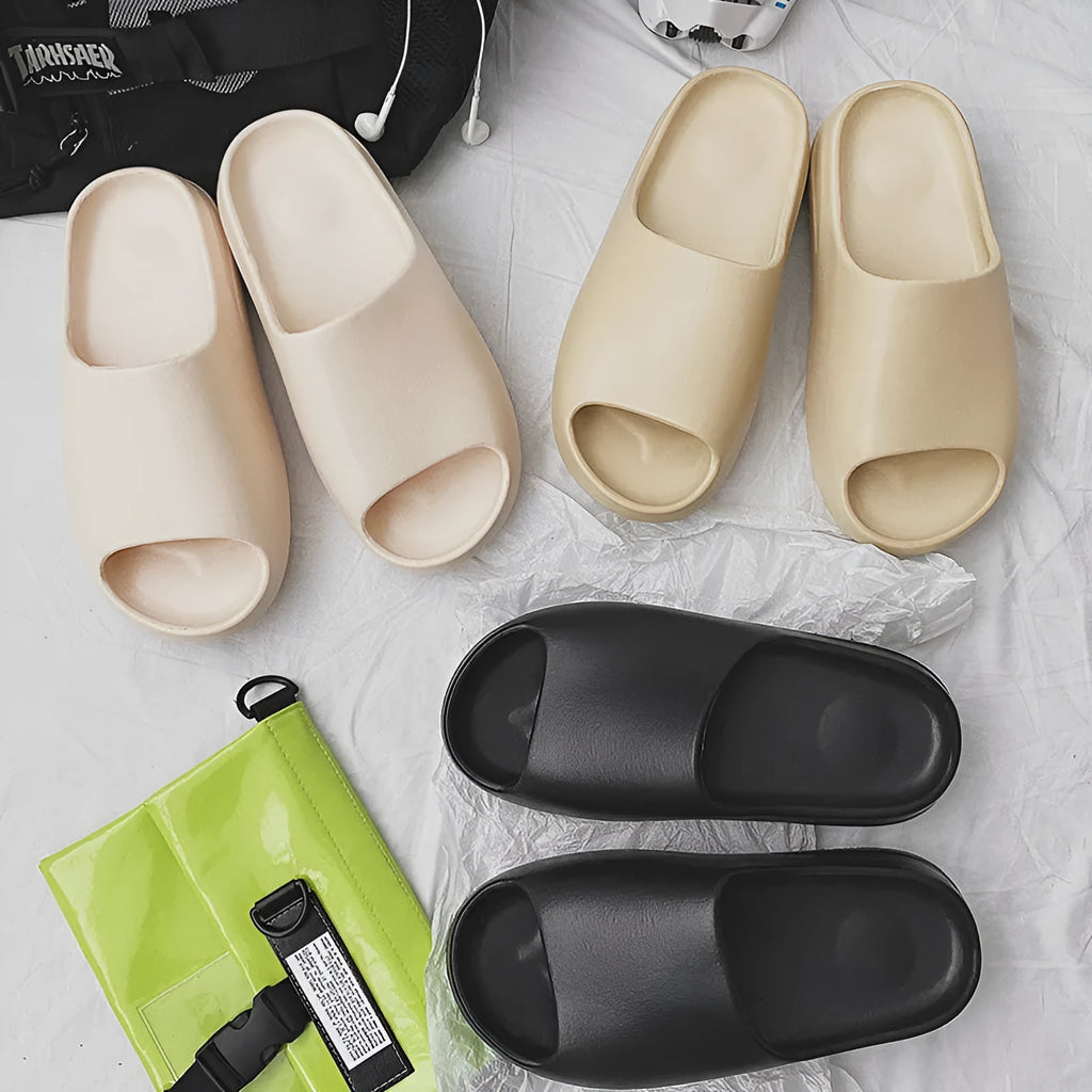 Women's thick-soled EVA beach slippers in black, green, or brown, showing injection moulded construction.