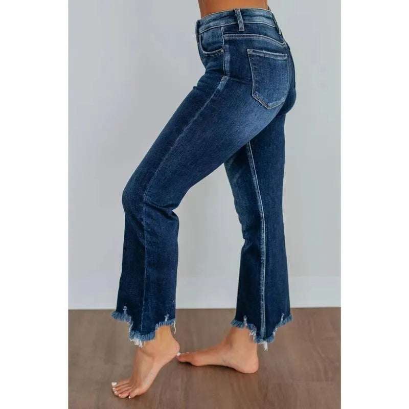 Solid colour women's cotton denim jeans with a hand-distressed finish in dark blue