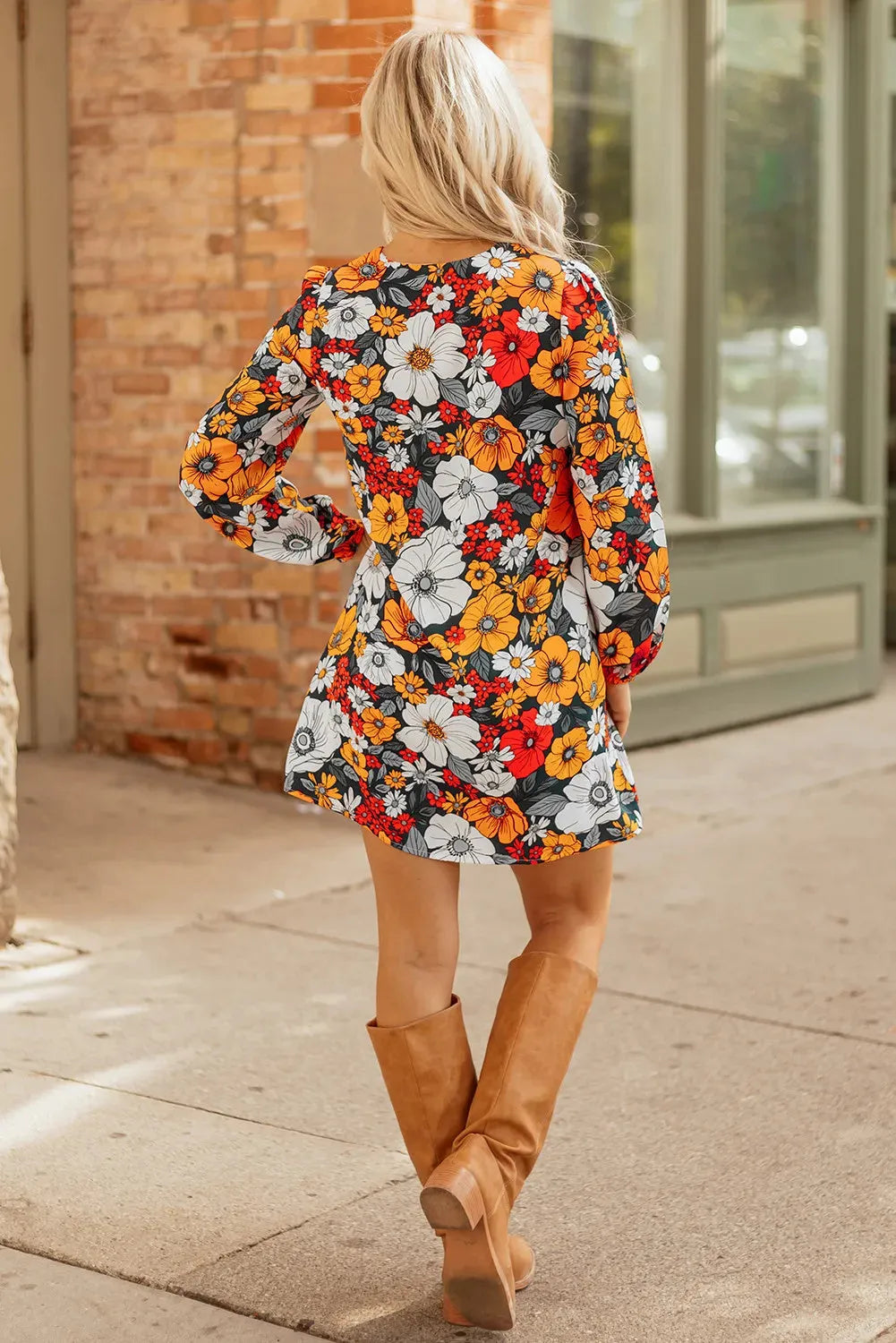 Orange floral stripe bodycon mini dress with V-neck and lace detailing on long sleeves.