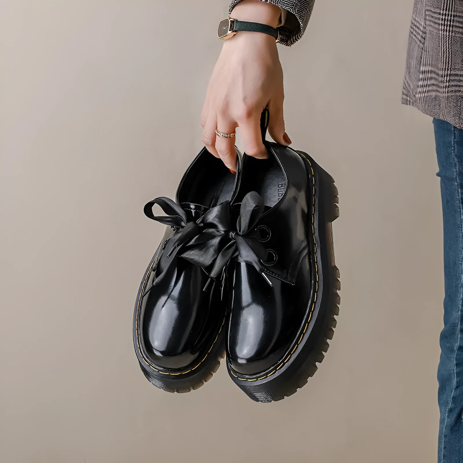 Women's black thick-soled lace-up shoes with white ribbon cross strap details on a superfine fibre upper.