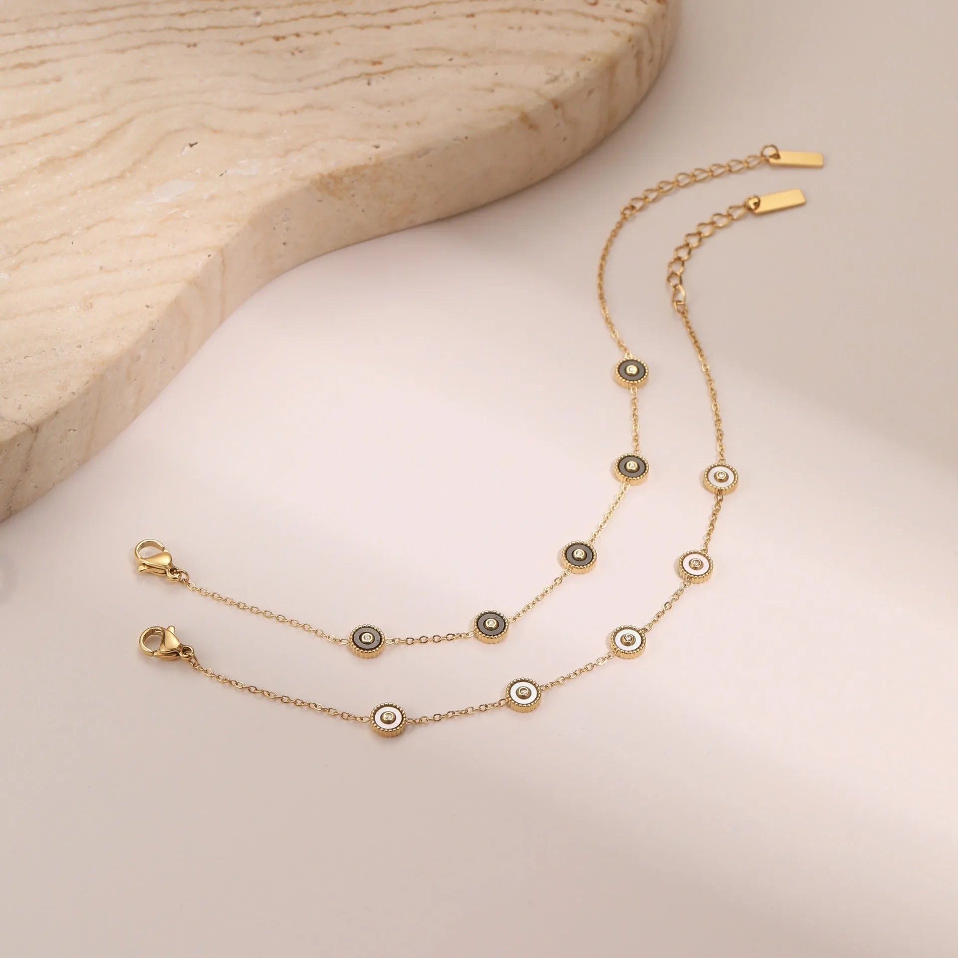 Women's stainless steel bracelet and necklace set with electroplated 18K gold finish in geometric design