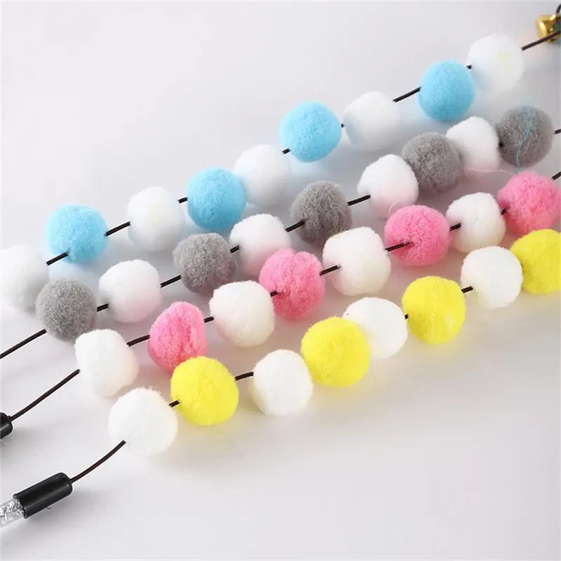 31cm long grey, yellow, and blue acrylic pompon cat teaser rod with feathers and a bell.