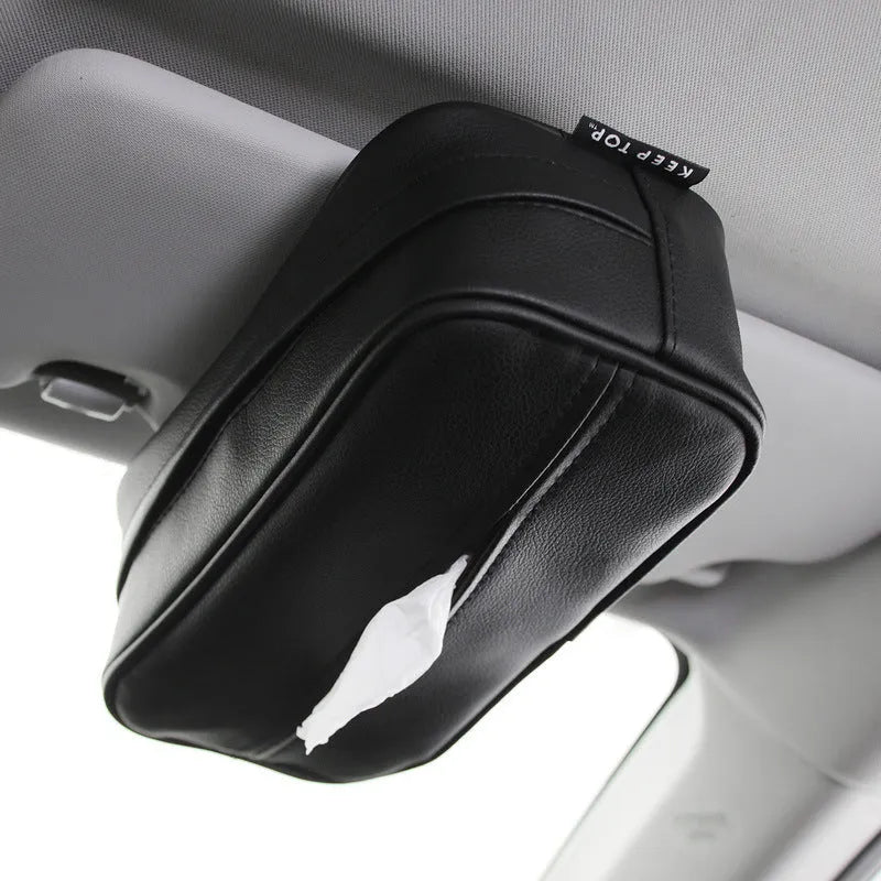Black PU leather car storage box with hanging straps shown on a car headrest.
