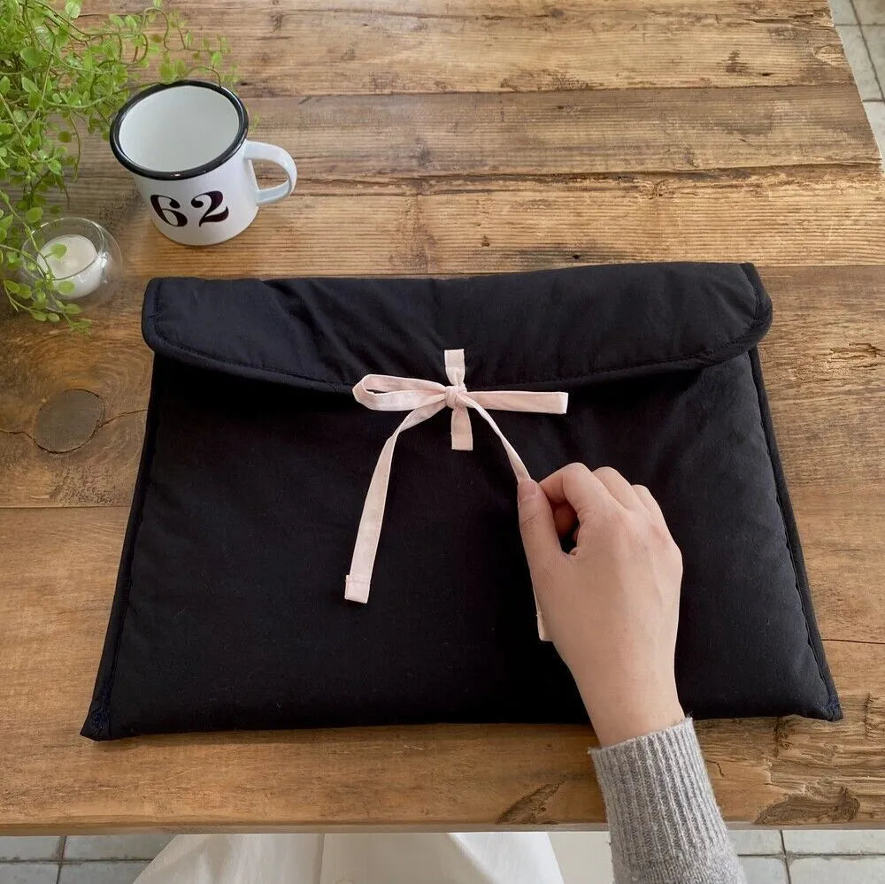 Women's black and white striped quilted laptop bag with ballet bow