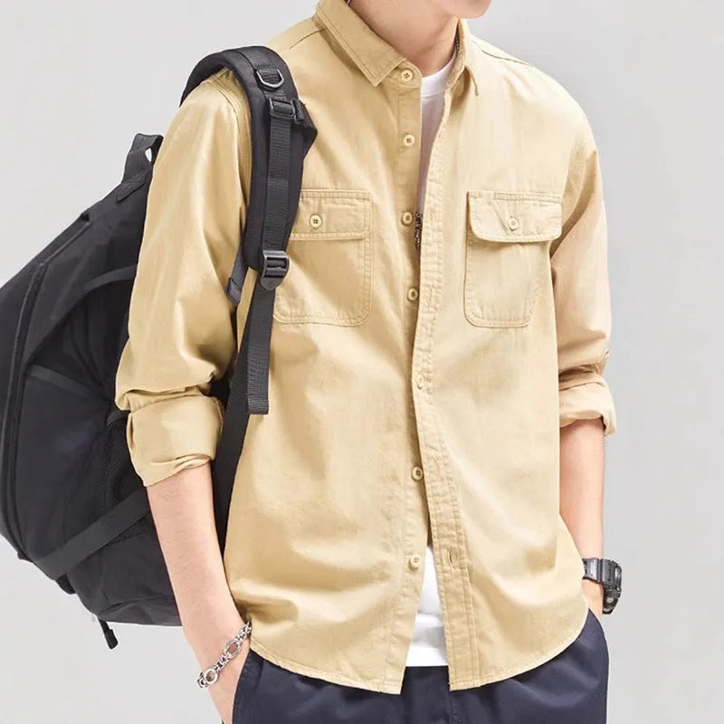 Man wearing a loose-fit grey long sleeve cardigan-style shirt, showcasing its relaxed silhouette and polyester material.