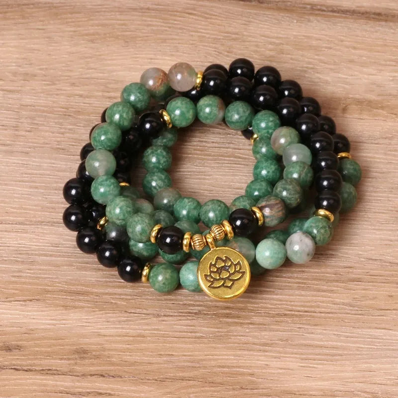 Green and black alloy beaded bracelet on an elastic cord