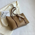 Large soft tote bag with crossbody strap shown in available colour options including black, khaki, white and pink