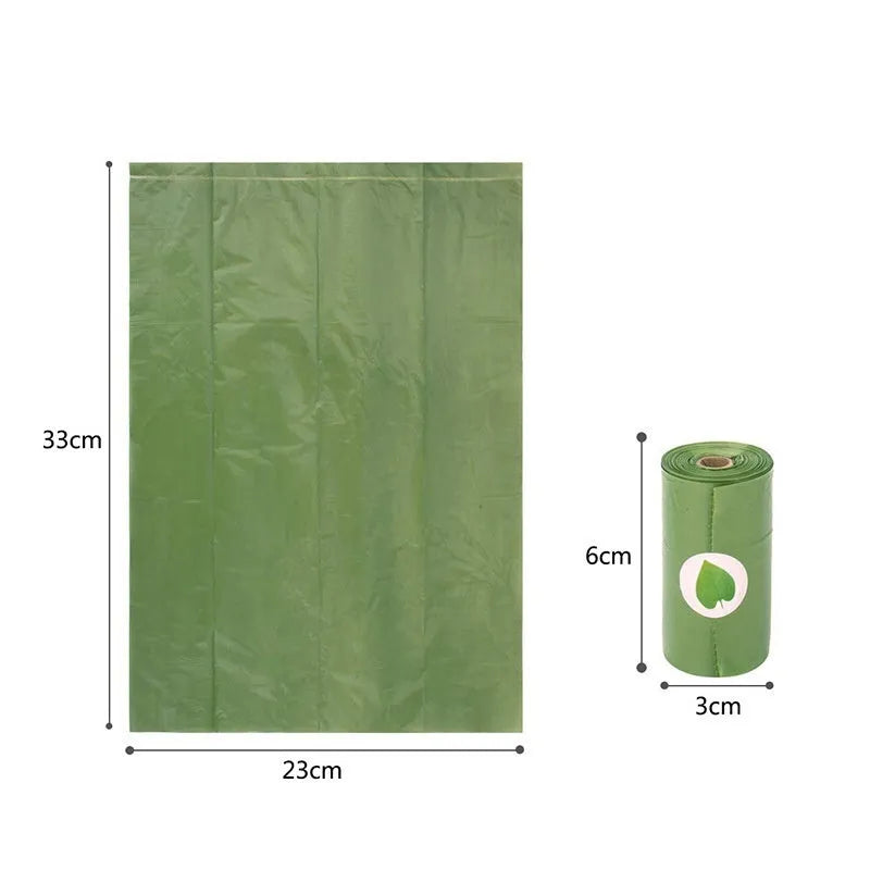 Roll of EPI degradable green dog poo bags next to a time-capsule-style dispenser on a grass background.