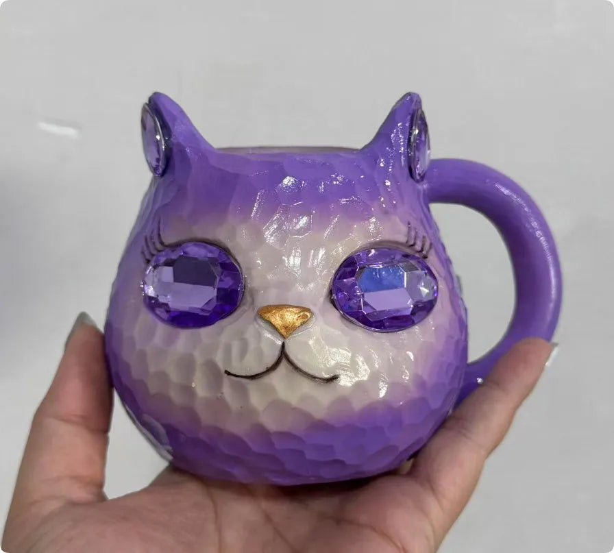 Decorative resin cat cup paperweight in American crafts style, shown in purple, green, blue, and pink colour options.