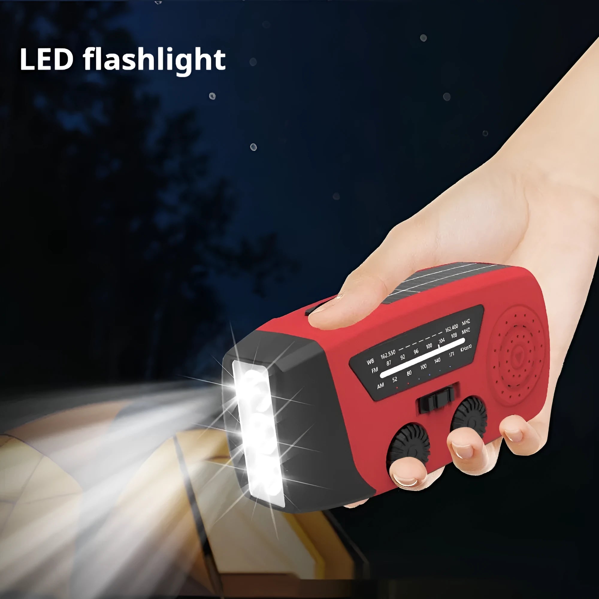 Red rechargeable emergency hand radio with torch, hand crank, and wrist strap on a white background.