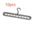 Green plastic nine-hole folding hanger for trousers shown open and folded.