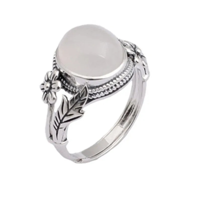 Adjustable vintage copper ring with a white imitation chalcedony stone on a U-shaped band.