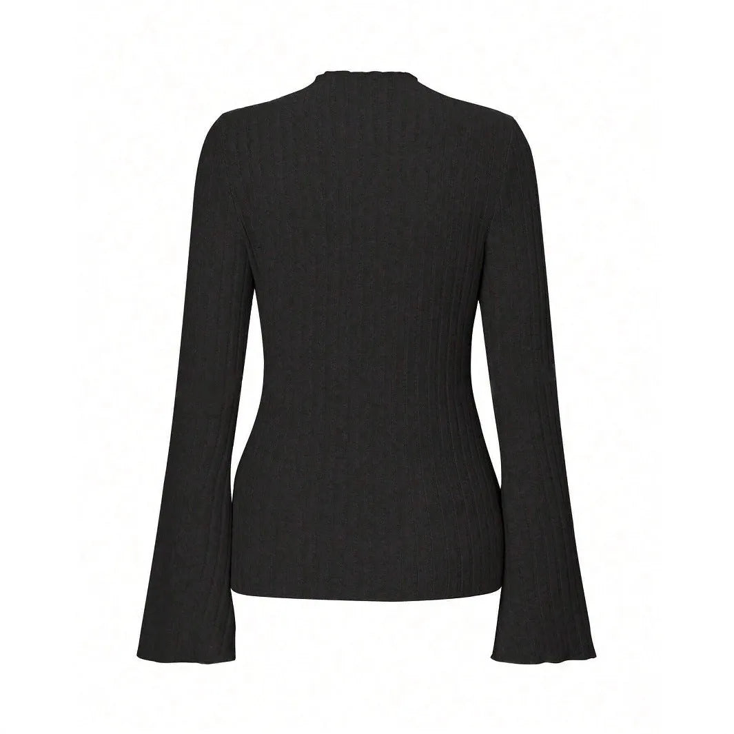 Man wearing a black slim fit long sleeve top with lantern sleeves and a round neck.