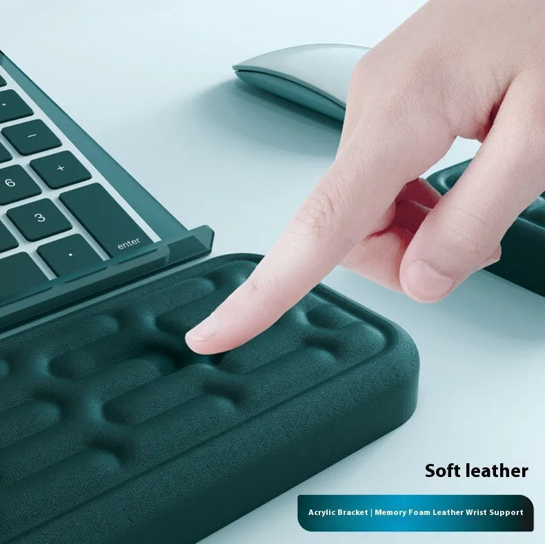 Double-sided black resin keyboard and mouse desk pad with integrated memory foam wrist rest.
