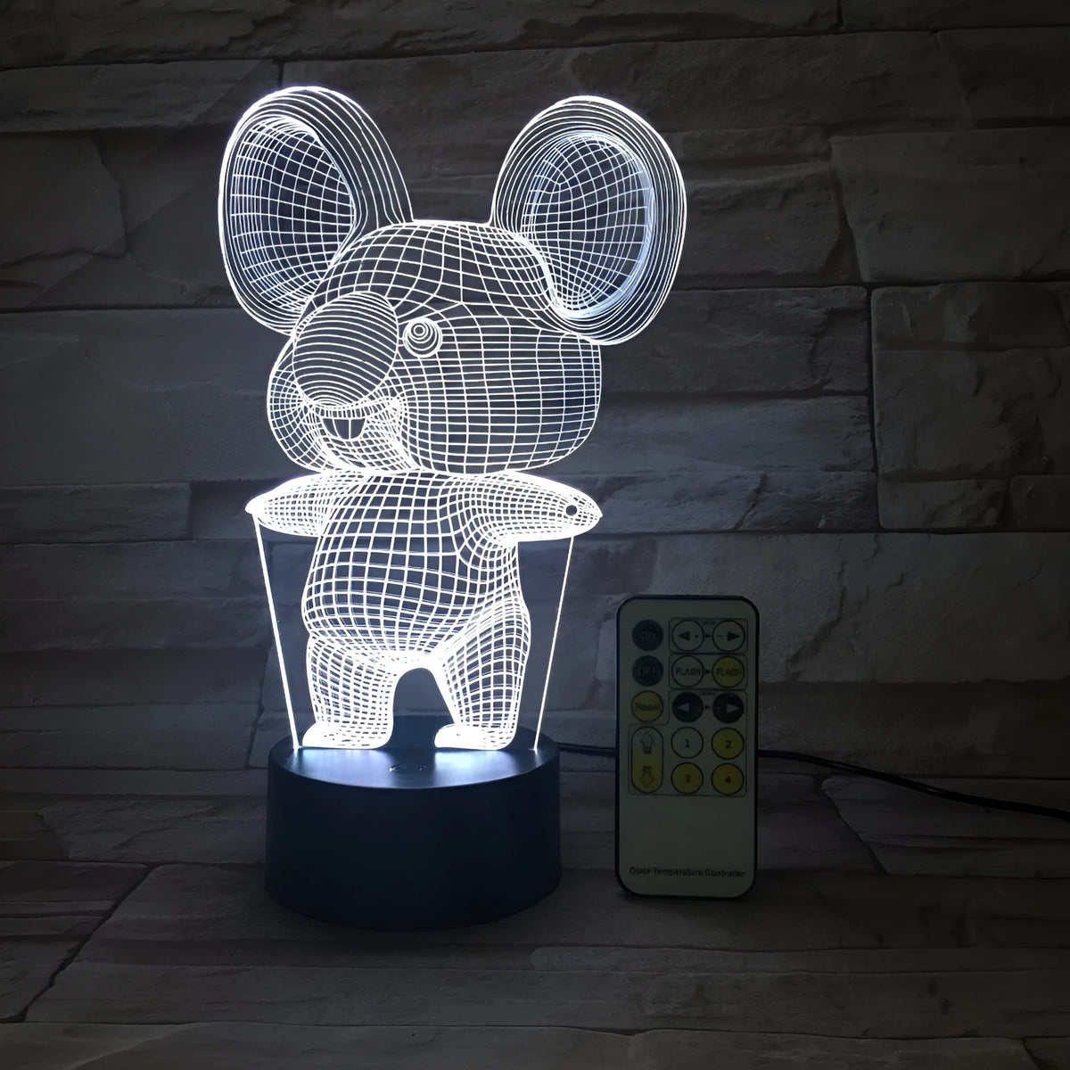 Black koala-shaped LED night light with remote control showing multiple colour illumination options